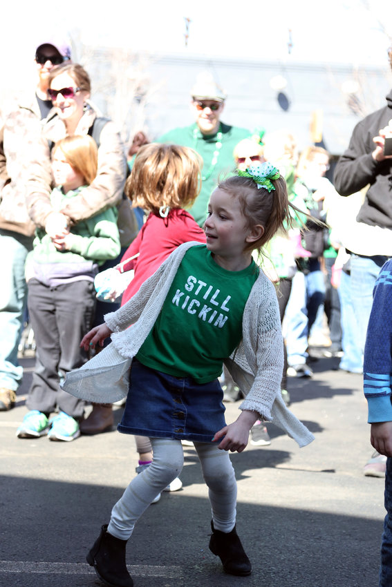 Paityn Gwash dances to the music at the St. Patrick’s Day festival in Olde Town Arvada.